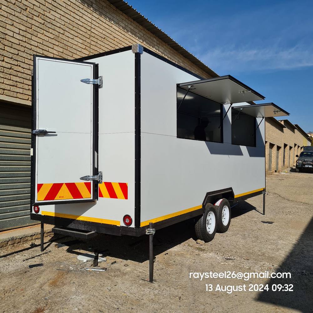 Large tandem-axle custom trailer with two service hatches and rear access